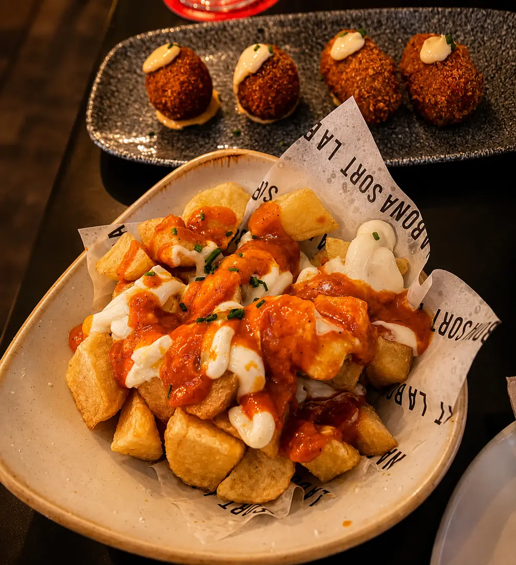 Patatas bravas up front and homemade croquettes behind