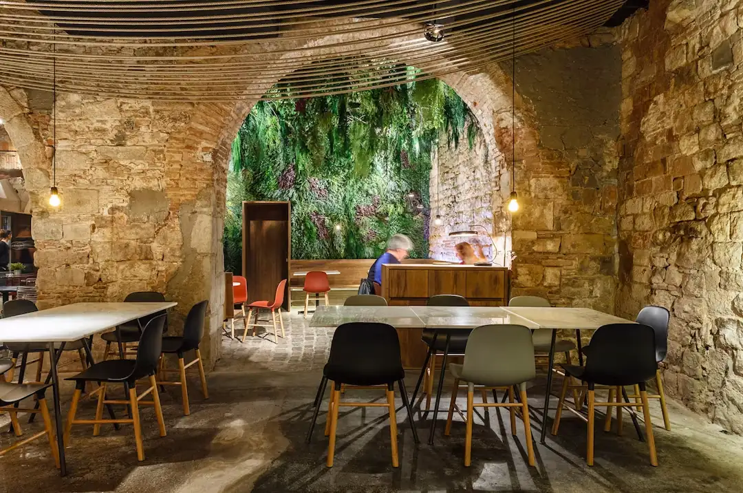 The long table in the dining room, under the arch and the green wall