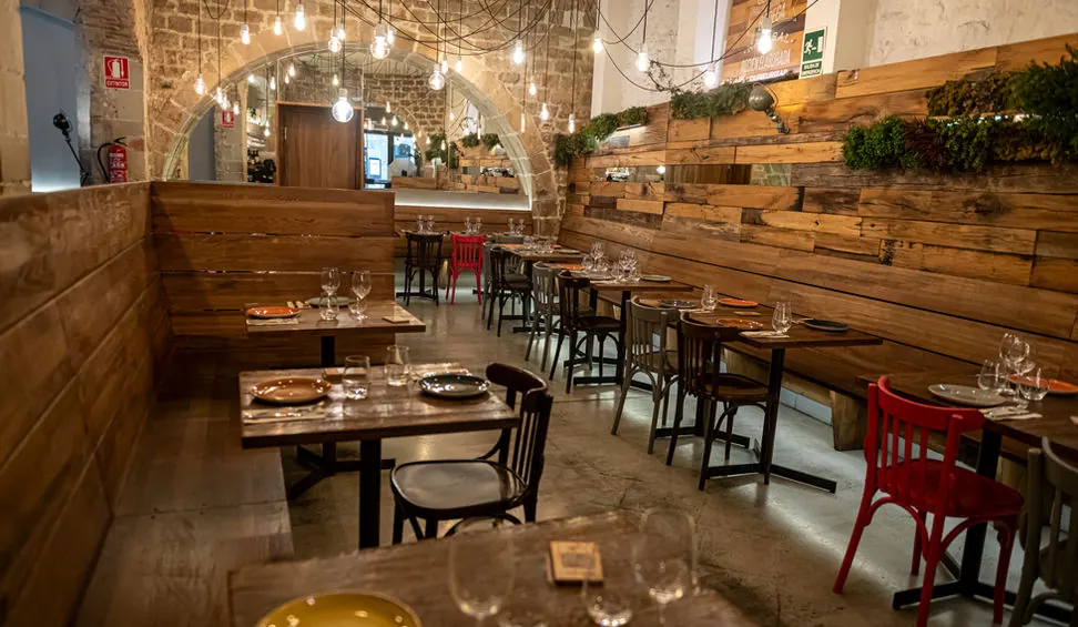 The long dining room at La Bona Sort, with the tables set