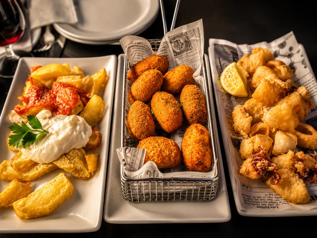 Three house tapas: bravas, croquettes and fried squid